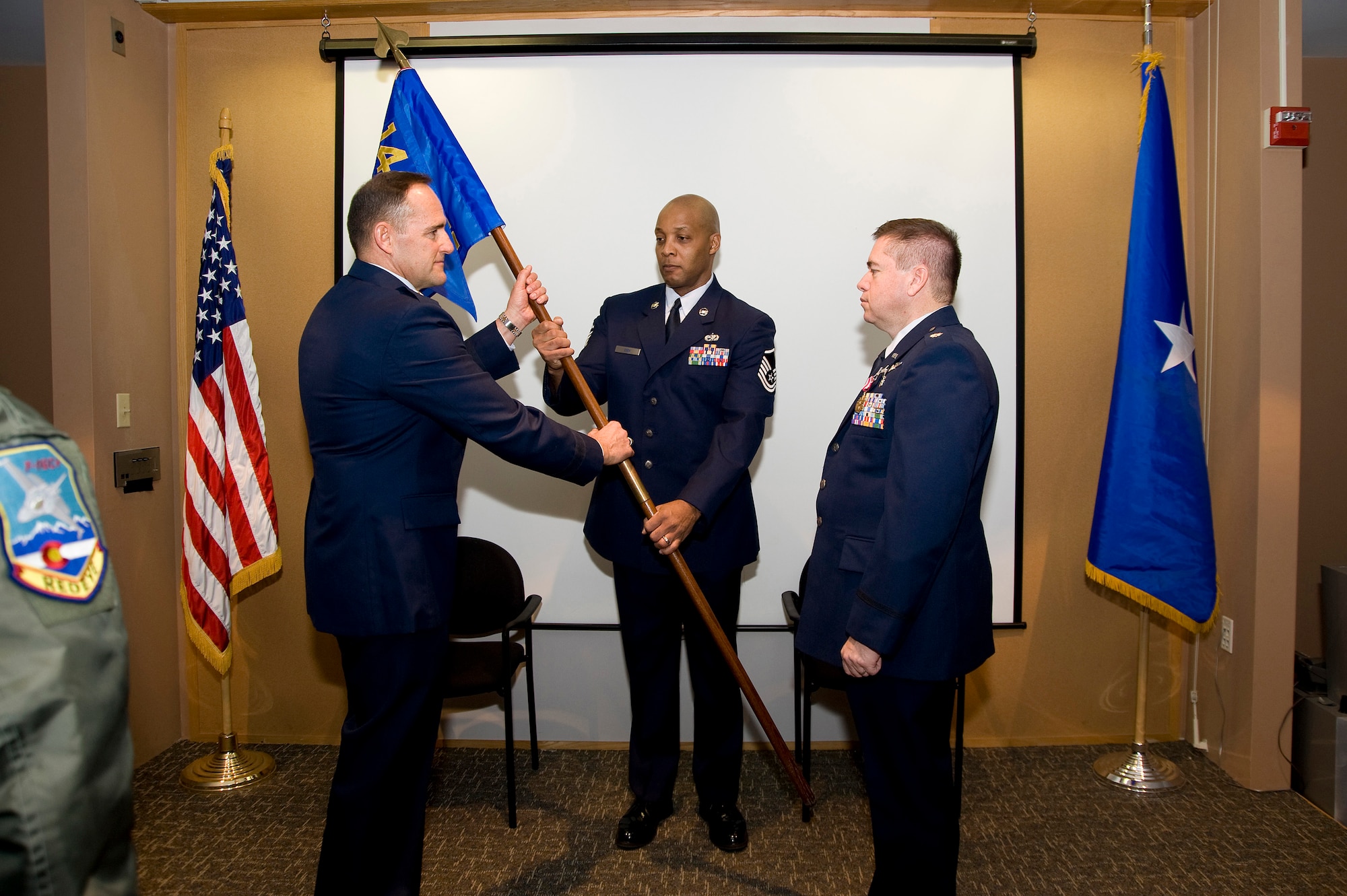 U.S. Air Force Brig. Gen. Trulan Eyre, 140th Wing Commander takes the 140th Medical Group Command Flag as he is about to present it to U.S. Air Force Lt. Col. Paul E. Shingledecker, 140th Interim Medical Group Commander, Buckley Air Force Base January 30, 2010.  Shingledecker is officially assuming  command of the 140th Medical Group after serving as the interim commander for 4 months.  (U.S. Air Force photo/Tech. Sgt. Wolfram M. Stumpf)(RELEASED)  