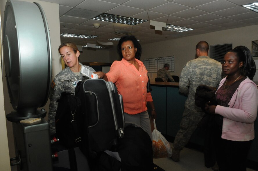 Nadia Jean-Lois of the Haitian Coast Guard, weighs her baggage for her flight to Haiti in support of Operation Unified Response, Jan. 23. The return flight home left Homestead Air Reserve Base, Fla., Jan. 24. (U.S. Air Force photo by Master Sgt. Sabrina Johnson/Released)