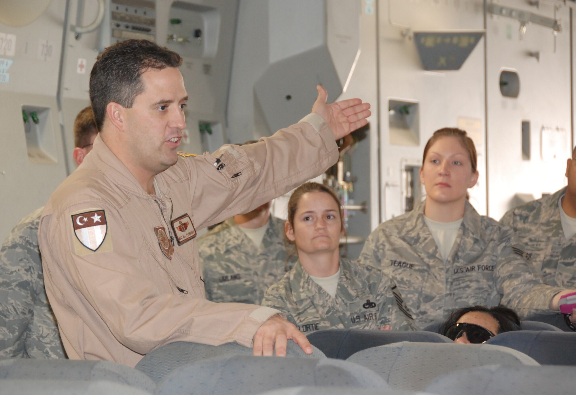 U.S. Air Force Master Sgt. Bill Flanders, 817th Expeditionary Airlift Squadron C-17 loadmaster, shows 386th Air Expeditionary Wing members the C-17 Globemaster Jan. 30, 2010 during the Quarry Open House at an air base in Southwest Asia. (U.S. Air Force photo by Staff Sgt. Lindsey Maurice/Released)