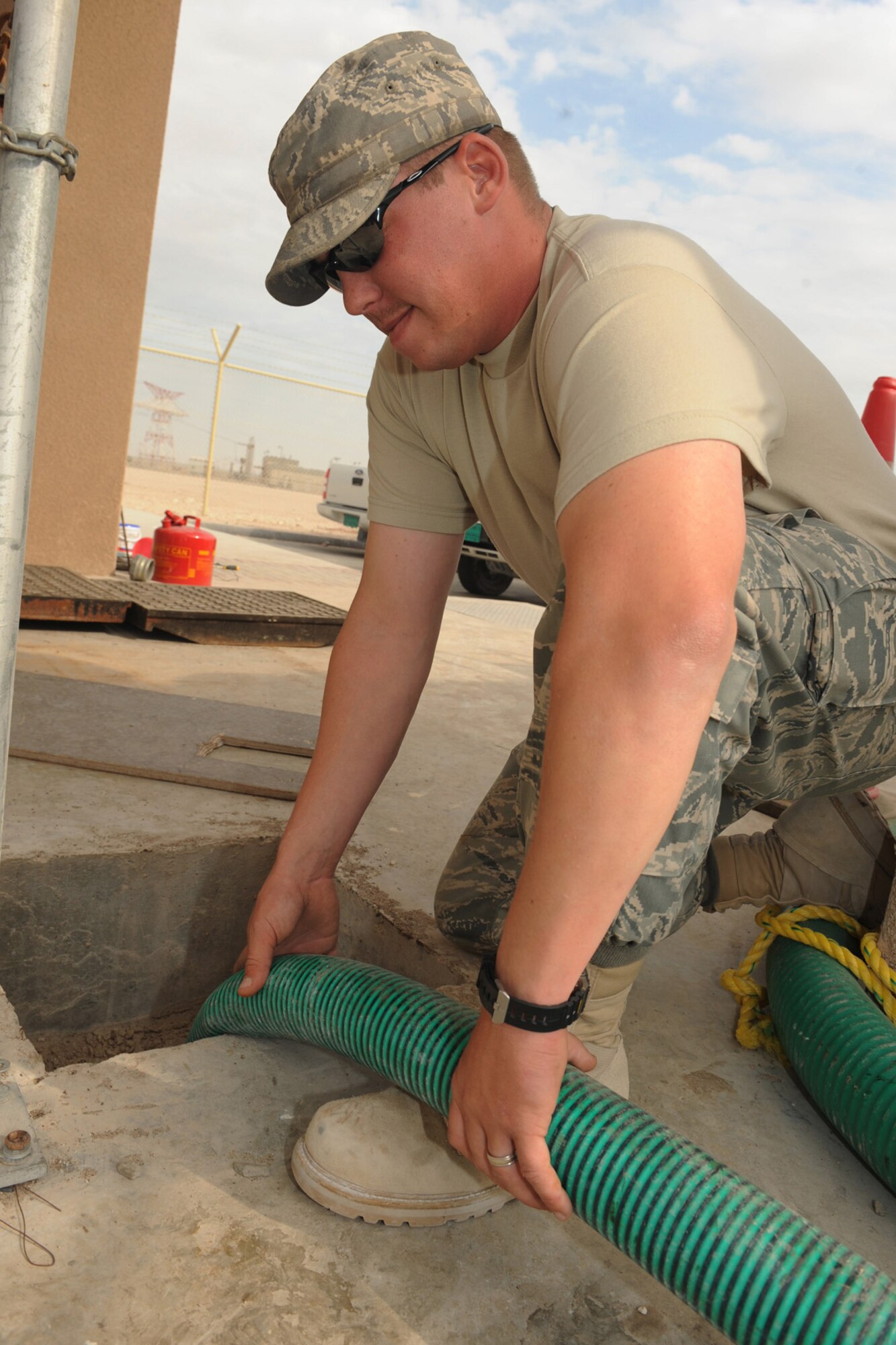 Staff Sgt. Brian McFall, 379 Expeditionary Civil Engineering Squadron water and fuels maintenance, prepares pump hoses at a sewage lift station at a non-disclosed Southwest Asia location, Jan. 25, 2010. (U.S. Air Force photo byTech. Sgt. Michelle Larche)[RELEASED]