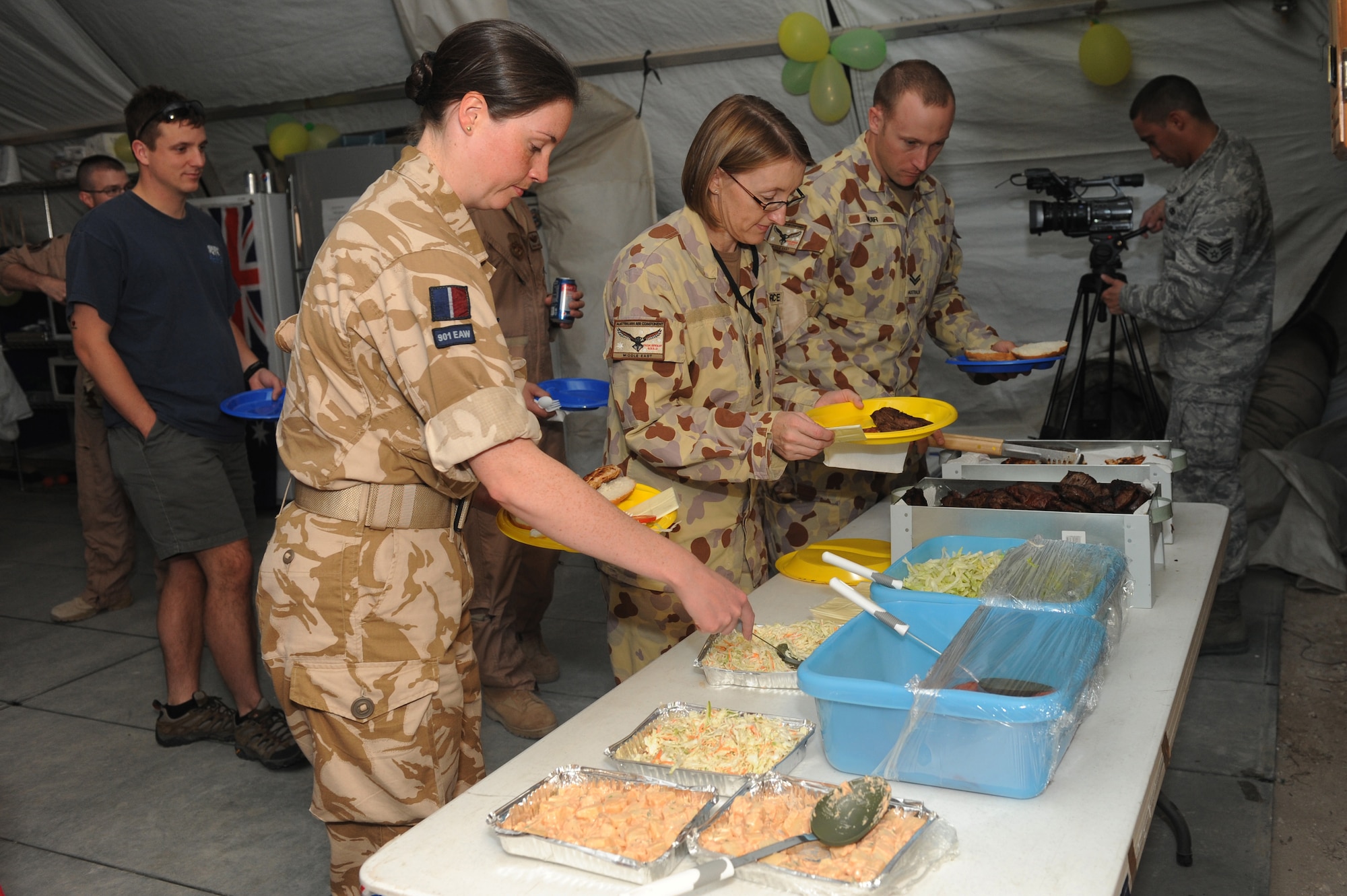 An Australian military contingent celebrated Australia Day at a non-disclosed Southwest Asia location, Jan. 26, 2010. The event included a barbecue, mingling with other Coalition forces and watching a broadcast of an Australian team competing in a cricket match. Celebrated annually, the day commemorates the arrival of the First Fleet at Sydney Cove in 1788, the hoisting of the British flag there and the proclamation of British sovereignty over the eastern seaboard of Australia. (U.S. Air Force photo byTech. Sgt. Michelle Larche)[RELEASED]