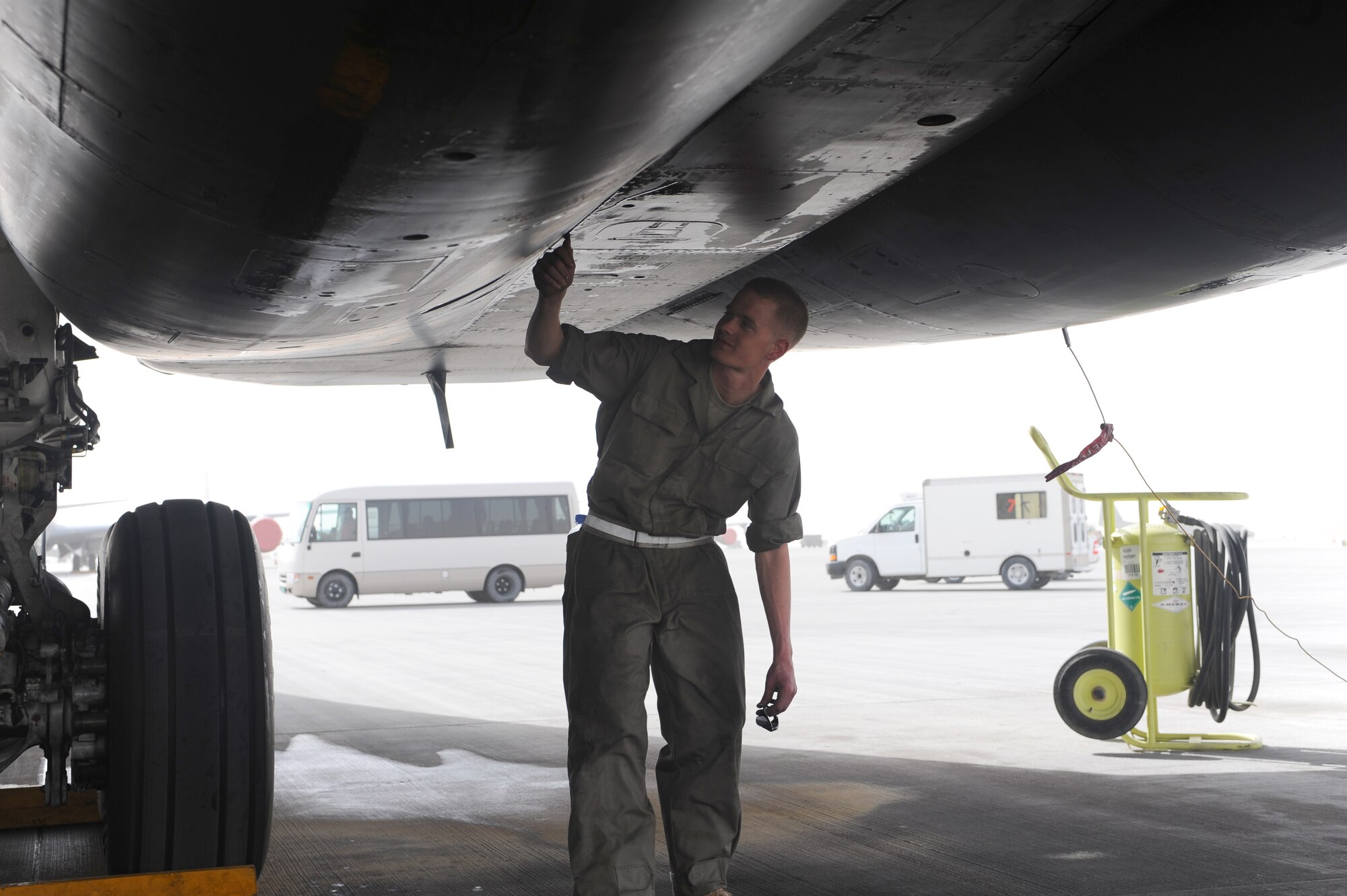 Staff Sergeant Christopher Snyder, 34th Aircraft Maintenance Unit B-1B Lancer crew chief, inspects the wing of a B-1 as part of a post-flight inspection at a non-disclosed Southwest Asia location Jan. 26, 2010. Sergeant Snyder is deployed from Ellsworth Air Force Base, S.D. (U.S. Air Force photo by Senior Airman Kasey Zickmund)[RELEASED]