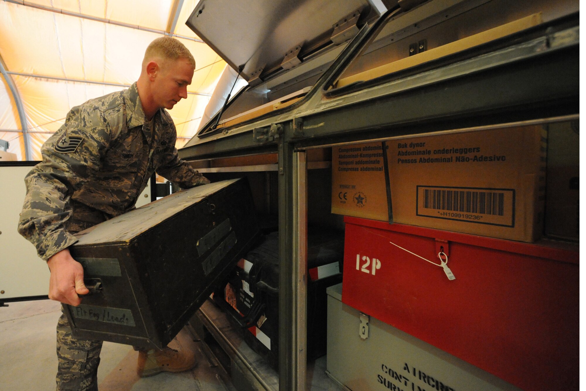Tech. Sgt. Danny Smith, 379th Expeditionary Operations Support Squadron aircrew flight equipment technician, packs  a pallet of training equipment at a non-disclosed Southwest Asia location, Jan. 25, 2010. The equipment will be delivered to Afghanistan for International Security Assistance Force Aircrew Flight Equipment trainers to teach Afghani instructors to train their airmen.  (U.S. Air Force photo by Tech. Sgt. Michelle Larche)[RELEASED]