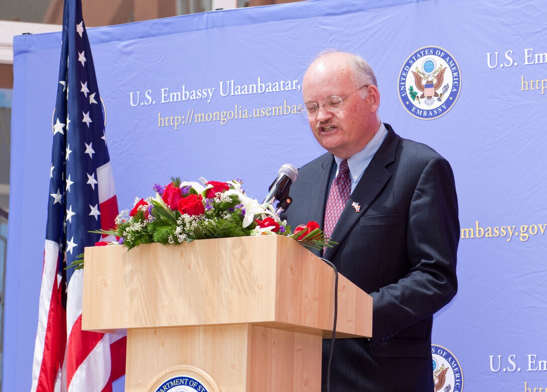 U.S. Ambassador to Mongolia Jonathan S. Addleton addresses official guests of the U.S. Embassy's Independence Day celebration at the International School of Ulaanbaatar, Mongolia, July 2. Addleton thanked the Marines for supporting the U.S. mission in and for sharing their time with the people of Mongolia.