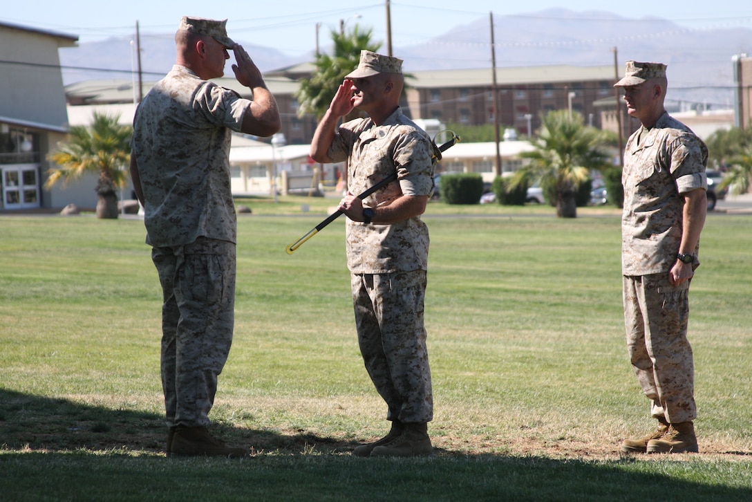 Lieutenant Col. Robert Piddock [left], the incoming commanding officer of 3rd Battalion, 4th Marine Regiment, returns a salute as Sgt. Maj. Jonathan Cagle, the battalion's sergeant major, prepares to pass the sword of office during the change of command ceremony at Lance Cpl. Torrey L. Grey Field July 2.
