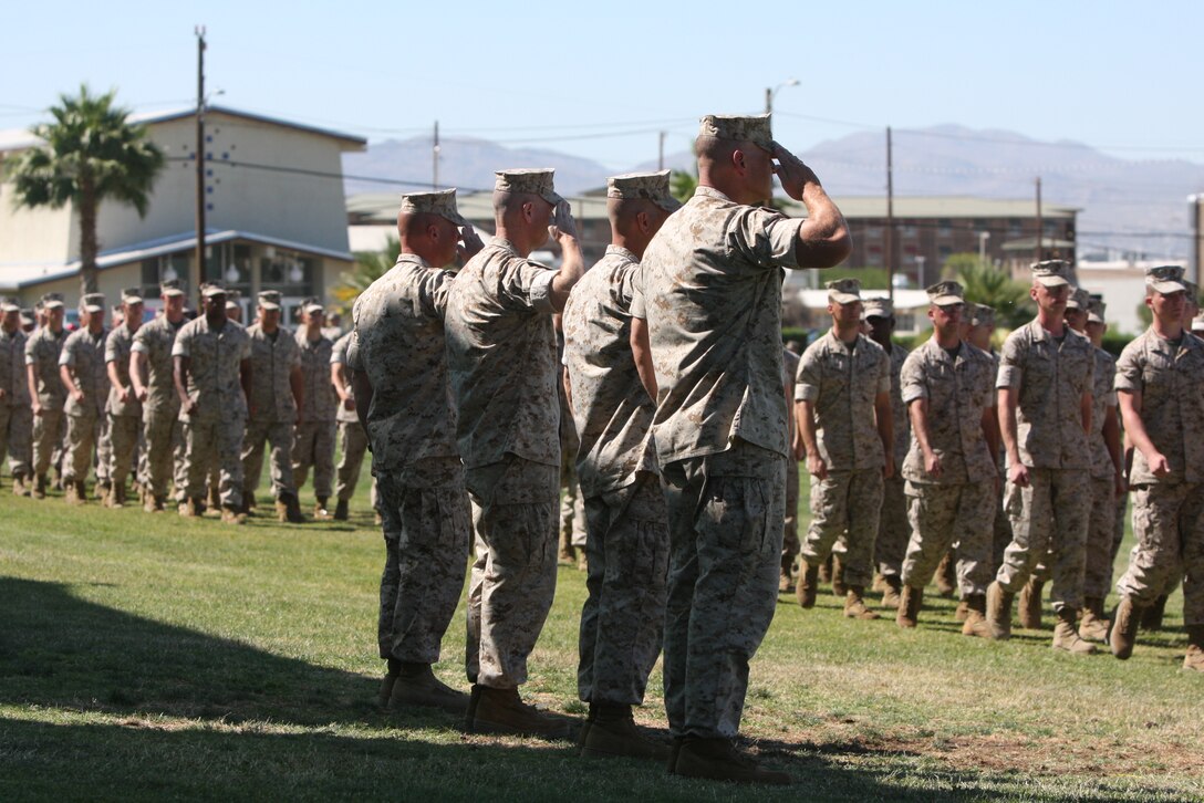 The incoming and outgoing commanders and their sergeants major render salutes during the pass and review at the 3rd battalion, 4th Marine Regiment's, change of command ceremony July 2.