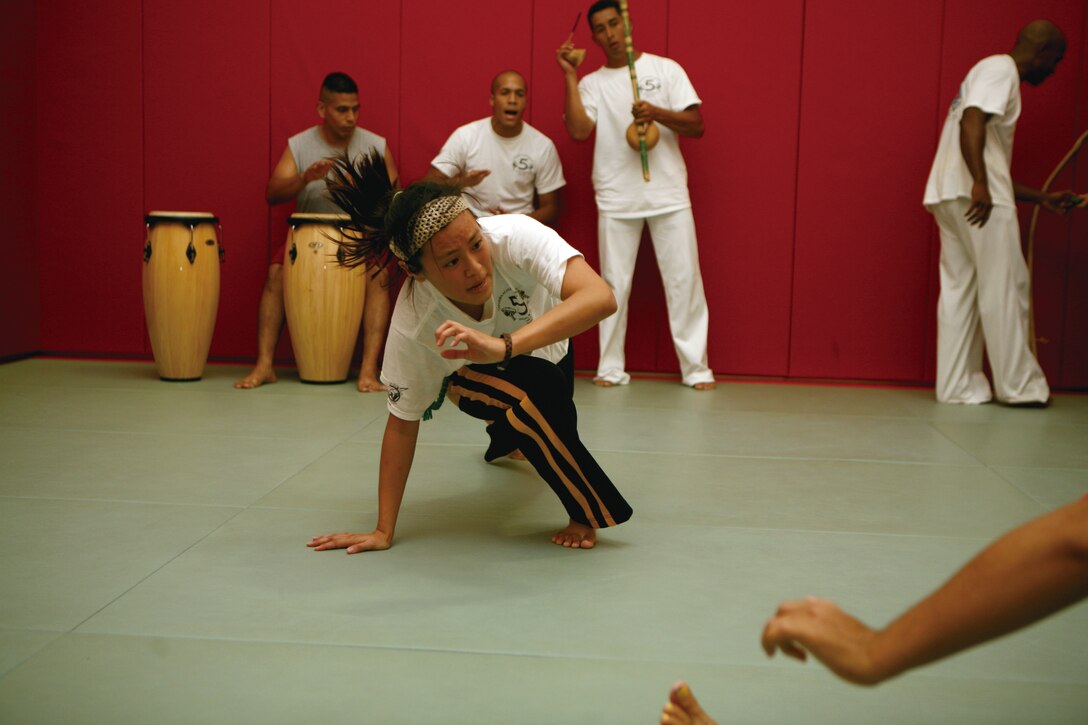 Kay Makishi, a foreign exchange student at the University of the Ryukyus practices her Capoeira at the Camp Kinser Sports Complex June 29.