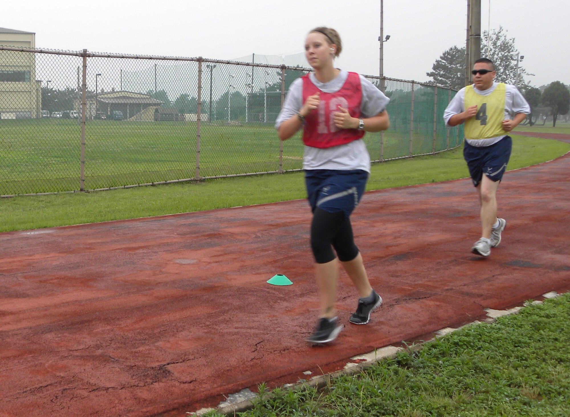KUNSAN AIR BASE, Republic of Korea -- Senior Airman Christina Reynoldson, 8th Force Support Squadron dining facility storeroom assistant, and Tech. Sgt. Timothy Wells, 8th Aircraft Maintenance Squadron aircraft section chief, complete the run portion of the Air Force physical training test July 1. The new PT test scoring standards began July 1. (U.S. Air Force photo/Staff Sgt. Amanda Savannah) 