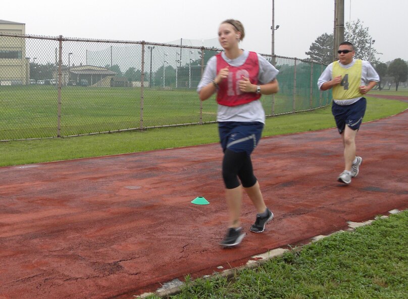 KUNSAN AIR BASE, Republic of Korea -- Senior Airman Christina Reynoldson, 8th Force Support Squadron dining facility storeroom assistant, and Tech. Sgt. Timothy Wells, 8th Aircraft Maintenance Squadron aircraft section chief, complete the run portion of the Air Force physical training test July 1. The new PT test scoring standards began July 1. (U.S. Air Force photo/Staff Sgt. Amanda Savannah) 
