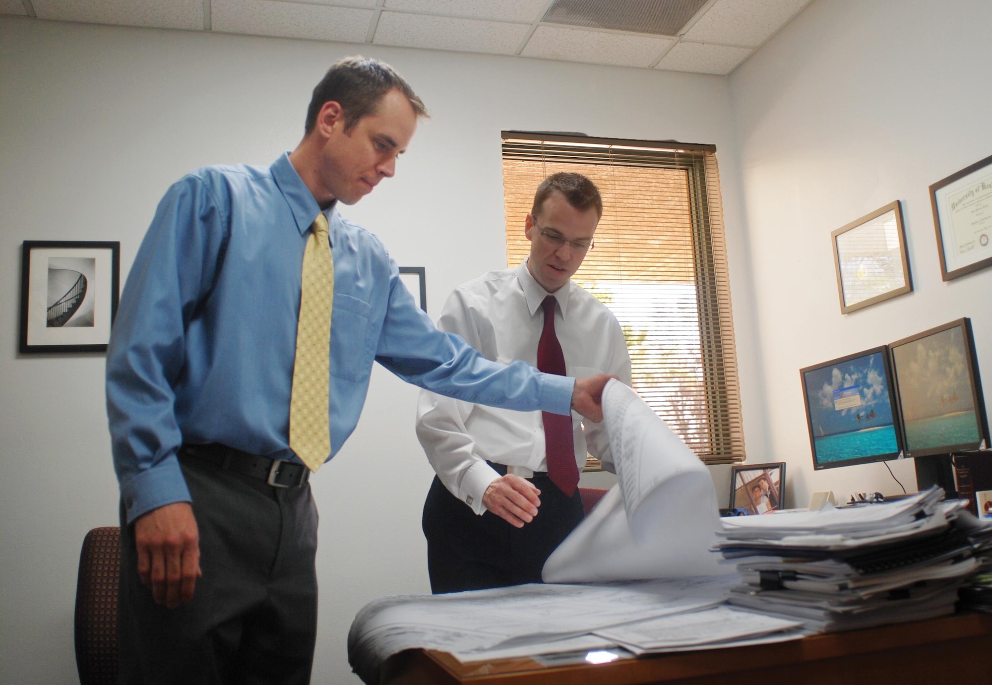 Ryan Wood (left), 452nd Civil Engineering deputy base civil engineer, and Sean Feeley, 452nd Civil Engineering chief engineer, review building 1221 renovation plans in Feeley’s office June 17. The planned renovations in the building include a new tool room and bench stock area, as well as an administrative area for C-17 maintenance, the addition of a fire protection system and energy efficient lighting. The planned renovations will give maintainers easier flight line access to tool kits. (U.S. Air Force photo by Megan Just)