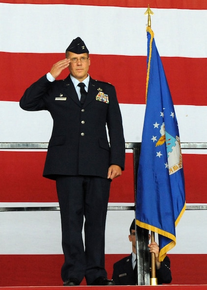 DYESS AIR FORCE BASE, Texas – Col. Todd G. McCready returns the first salute as group commander of the 7th Maintenance Group June 30 at the 3-Bay Hangar here.  Colonel McCready received his commission in 1987 through the Reserve Officer Training Corps. He is a career aircraft maintenance officer who briefly cross trained into transportation. (U.S. Air Force Photo/Airman 1st Class Chelsea Cummings)