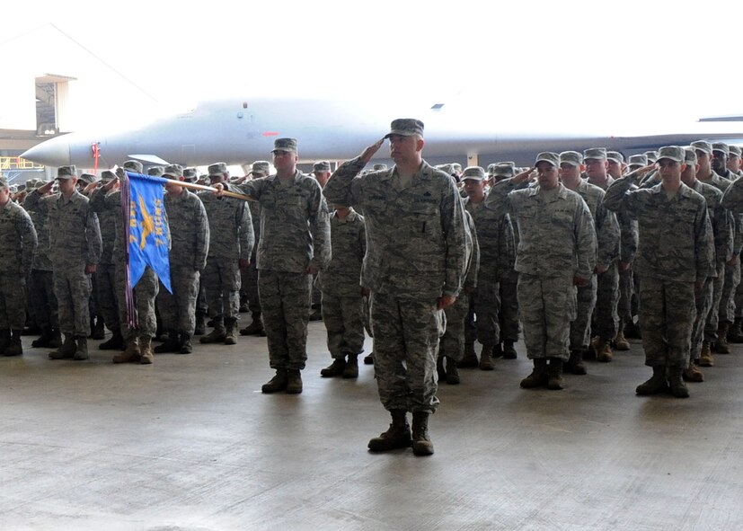 DYESS AIR FORCE BASE, Texas – The 7th Maintenance Group renders the first salute to their new commander Col. Todd G. McCready June 30 at the 3-Bay Hangar here. Colonel McCready received his commission in 1987 through the Reserve Officer Training Corps. He is a career Aircraft Maintenance Officer who briefly cross trained into transportation. (U.S. Air Force Photo/Airman 1st Class Chelsea Cummings)