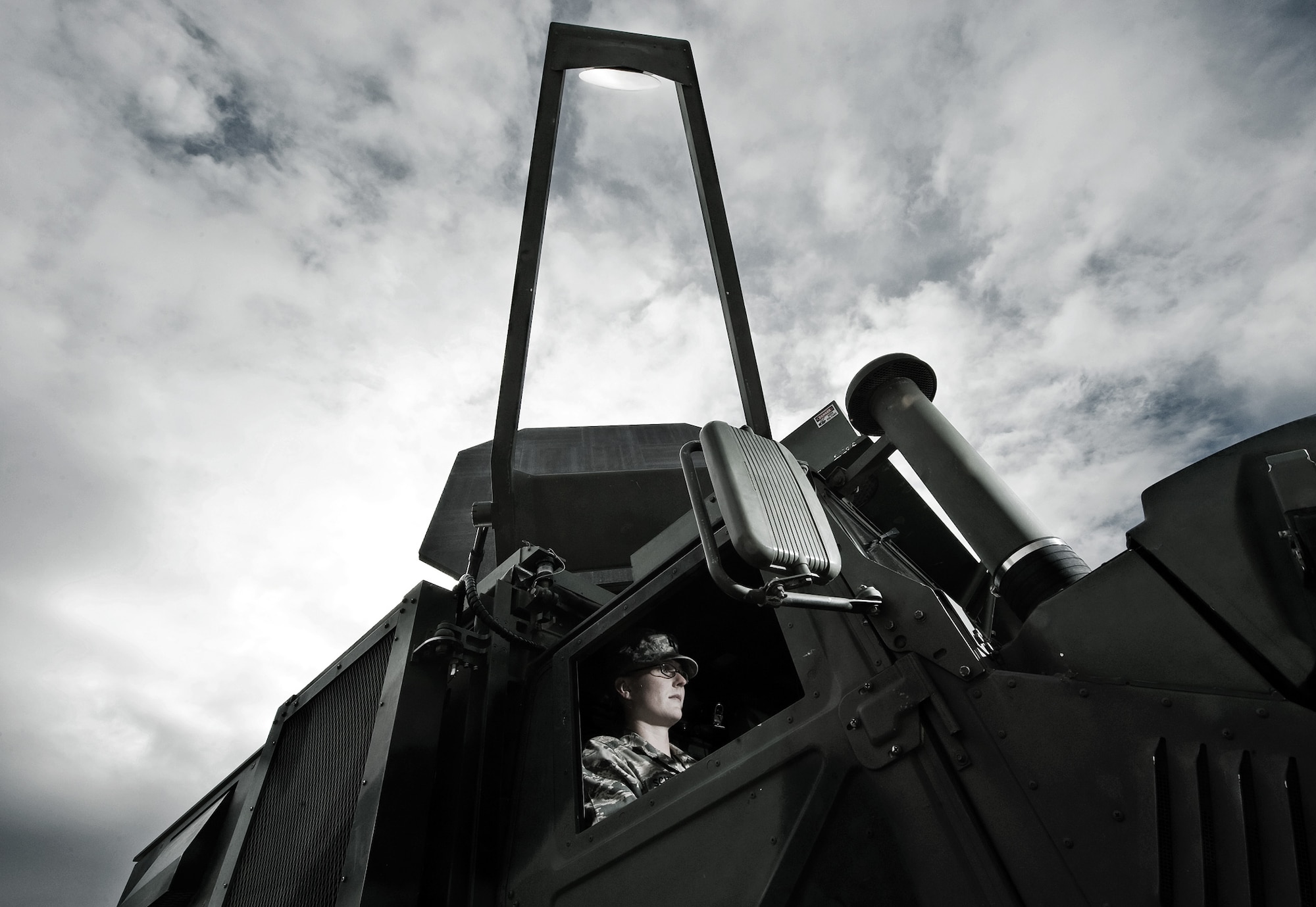 Capt. Katrina Schweiker maneuvers the antenna on test system 1 of the Active Denial System, a humvee mounted version at the Air Force Research Laboratory at Kirtland Air Force Base, N.M. ADS is a counter-personnel, non-lethal, directed-energy weapon. The ADS focuses beams of millimeter waves that induce the sensation of intolerable heat on an adversary's skin. When the enemy steps away, the skin returns to normal temperature. The enemy is repelled without permanent injury. (U.S. Air Force photo/Staff Sgt. Bennie J. Davis III)
