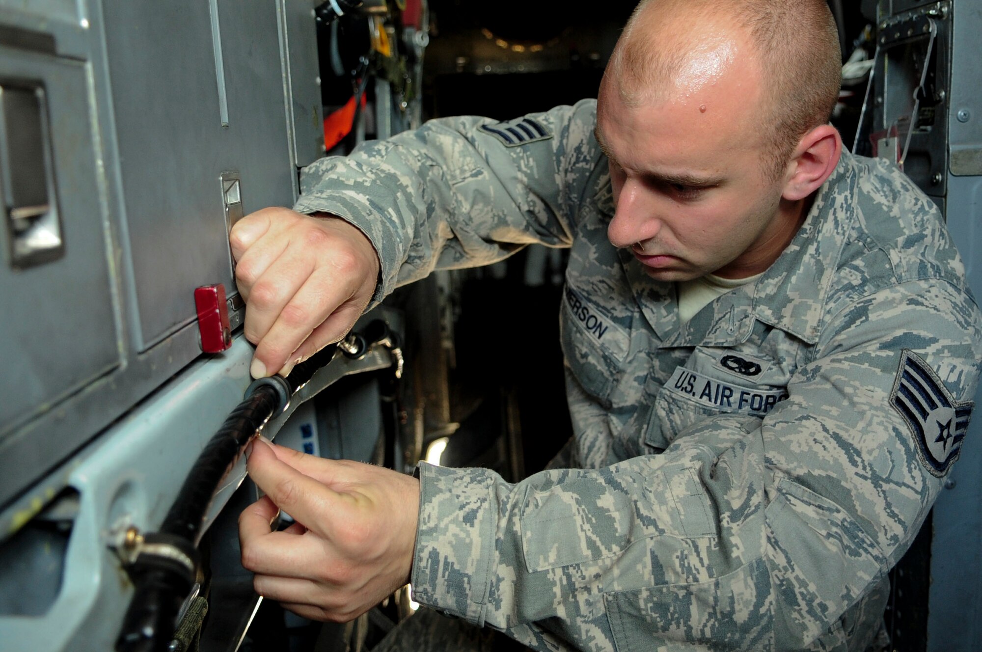 ELLSWORTH AIR FORCE BASE, S.D. - Staff Sgt. Bradley Emerson, 28th Aircraft Maintenance Squadron offensive avionics specialist, examines a video display signal cable for any damage, June 30.  This video display cable is connected to a B-1B Lancer sniper pod, which provides video for weapons system officers while flying. (U.S. Air Force Photo/Airman 1st Class Corey Hook)