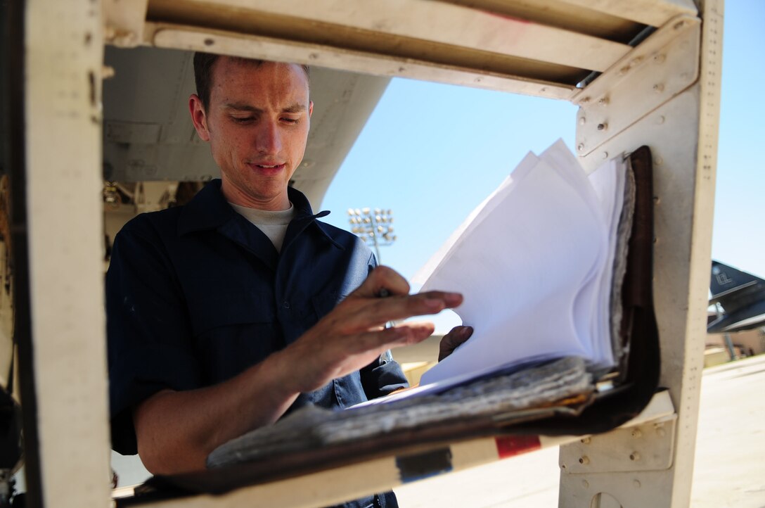 ELLSWORTH AIR FORCE BASE, S.D. -- Senior Airman Sean Hoke, 28th Aircraft Maintenance Squadron crew chief, looks over a B-1B Lancer checklist, June 30. Crew chiefs of the 28th AMXS maintain B-1B Lancers, the backbone of America’s long range bomber force. (U.S. Air Force Photo/Airman 1st Class Corey Hook)