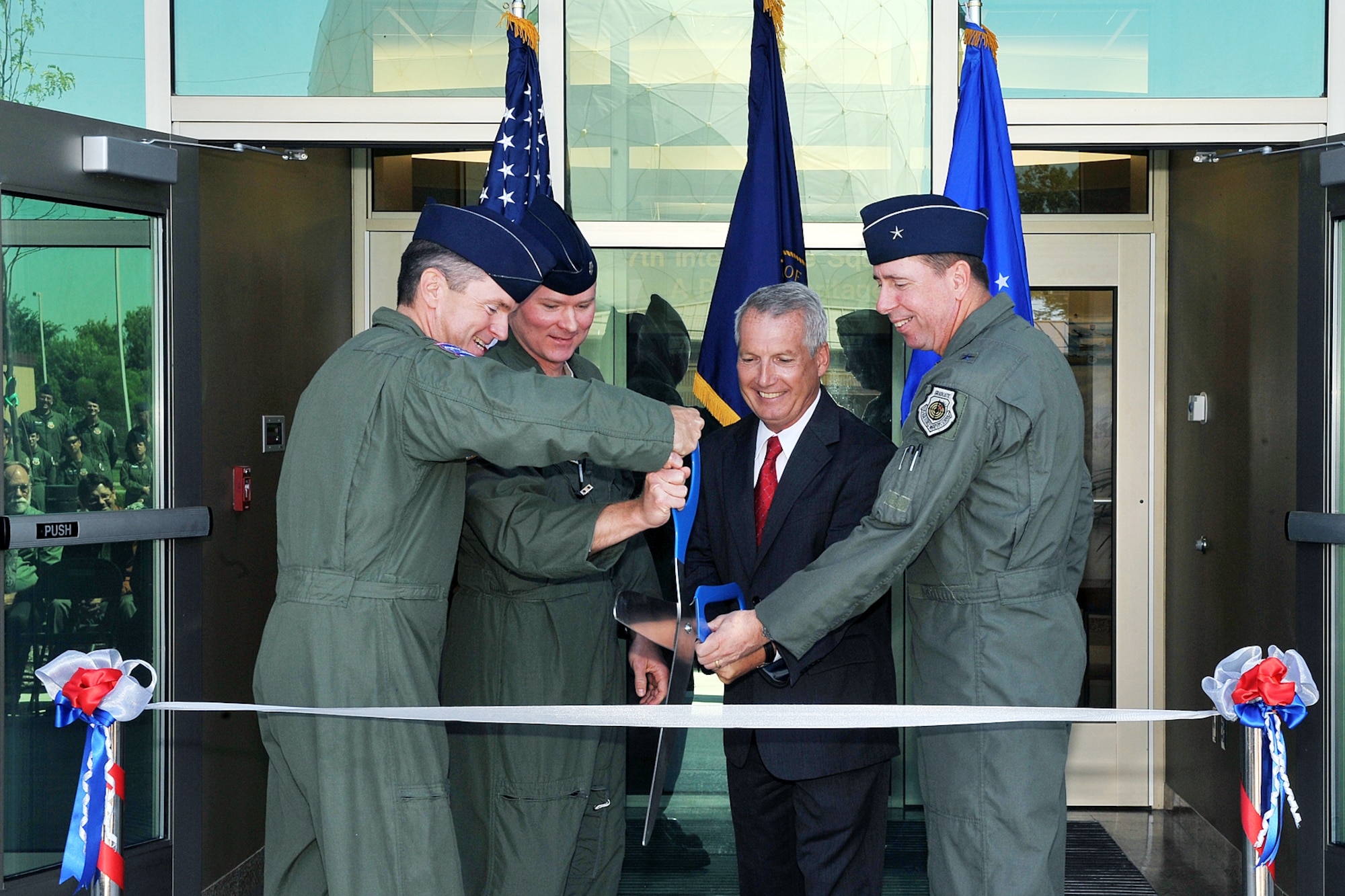 OFFUTT AIR FORCE BASE, Neb. - Col. John Hansen, 55th Operations Group commander, Lt. Col. Shane Smith, 97th Intelligence Squadron commander, Jay Hodges, U.S. Army Corps of Engineers, Omaha District and Brig. Gen. John N.T. Shanahan cut the ribbon at a ceremony for the 97th IS' new building June 29. The new 54,000 square foot building is primarily a special compartmented information facility to support the squadron's approximately 850 personnel and is the base's second Silver Level Leadership in Energy and Environmental Design Green building. U.S. Air Force photo by Charles Haymond 
