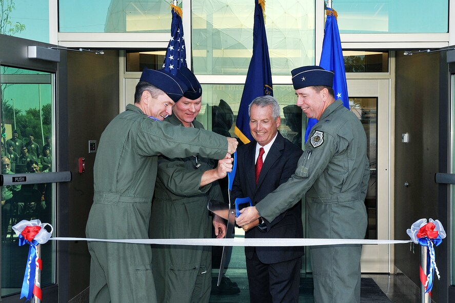 OFFUTT AIR FORCE BASE, Neb. - Col. John Hansen, 55th Operations Group commander, Lt. Col. Shane Smith, 97th Intelligence Squadron commander, Jay Hodges, U.S. Army Corps of Engineers, Omaha District and Brig. Gen. John N.T. Shanahan cut the ribbon at a ceremony for the 97th IS' new building June 29. The new 54,000 square foot building is primarily a special compartmented information facility to support the squadron's approximately 850 personnel and is the base's second Silver Level Leadership in Energy and Environmental Design Green building. U.S. Air Force photo by Charles Haymond 