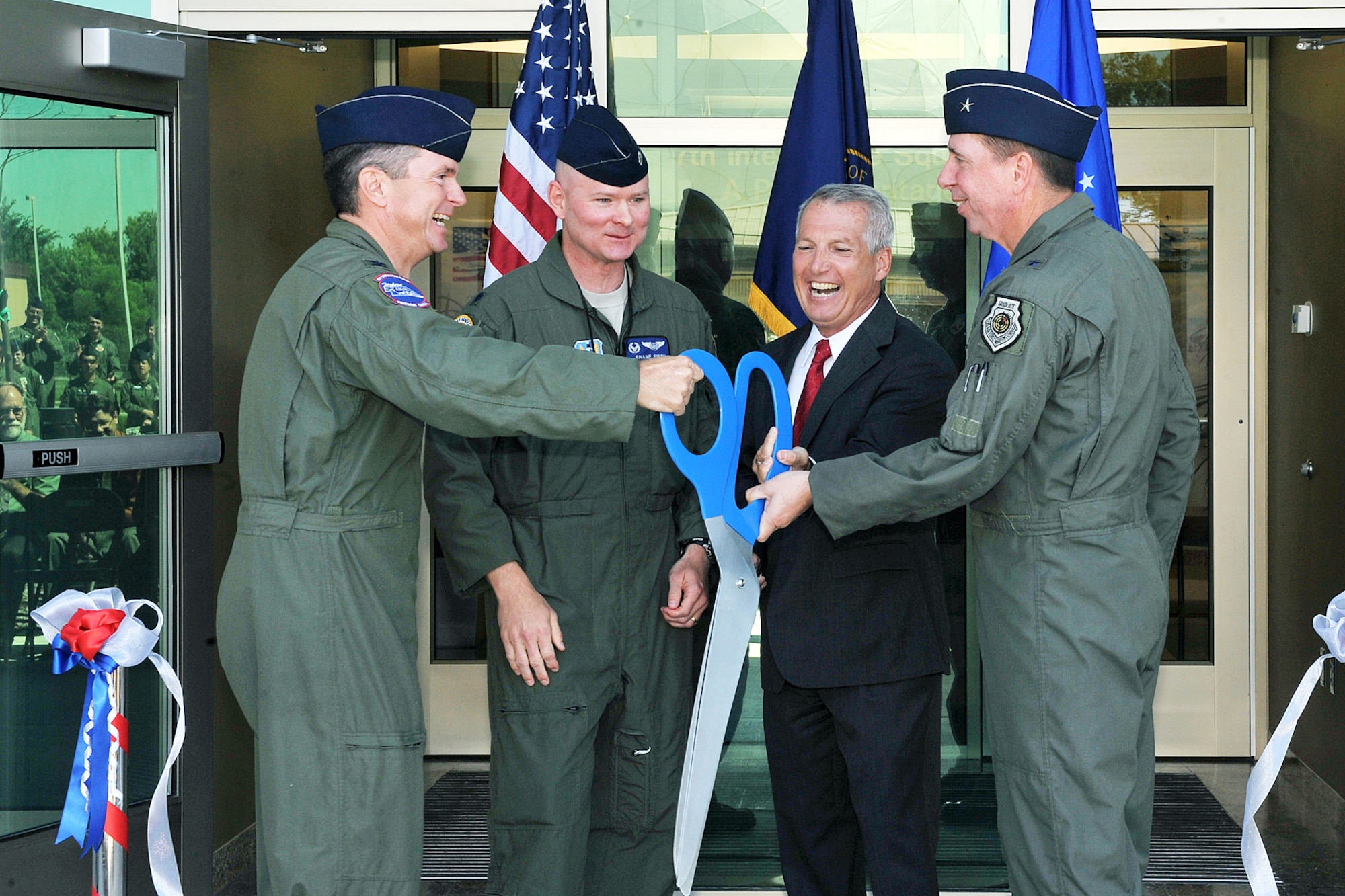 OFFUTT AIR FORCE BASE, Neb. - Col. John Hansen, 55th Operations Group commander, Lt. Col. Shane Smith, 97th Intelligence Squadron commander, Jay Hodges, U.S. Army Corps of Engineers, Omaha District and Brig. Gen. John N.T. Shanahan cut the ribbon at a ceremony for the 97th IS' new building June 29. The new 54,000 square foot building is primarily a special compartmented information facility to support the squadron's approximately 850 personnel and is the base's second Silver Level Leadership in Energy and Environmental Design Green building. U.S. Air Force photo by Charles Haymond 
