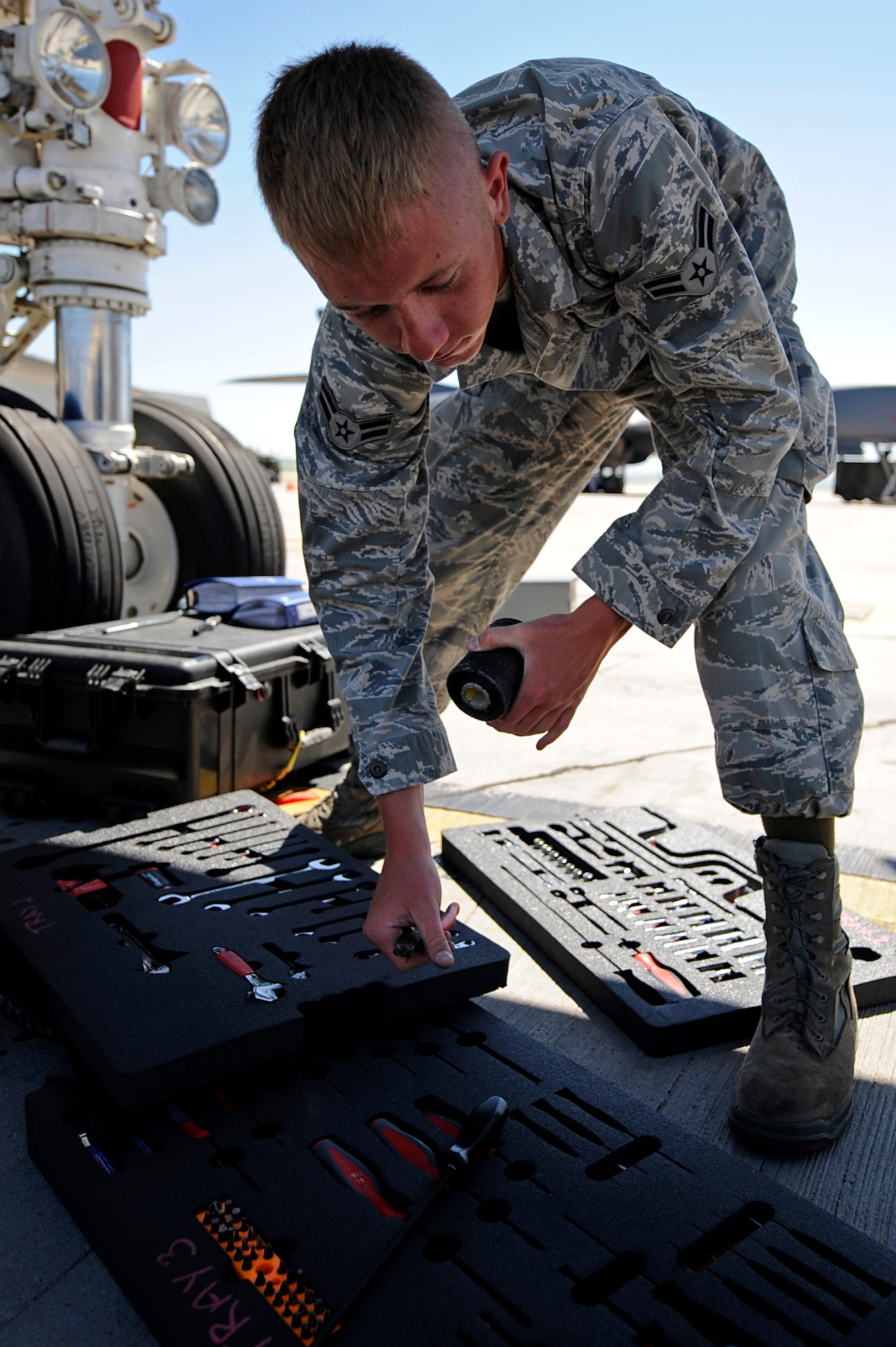 ELLSWORTH AIR FORCE BASE, S.D. – Airman 1st Class Darrick Coxson, 28th Aircraft Maintenance Squadron offensive avionics technician, performs a tool inventory and foreign object debris check, June 30. Airman Coxson performs the check to ensure safety for the aircraft on the flightline. (U.S. Air Force photo/Airman 1st Class Matthew Flynn)
