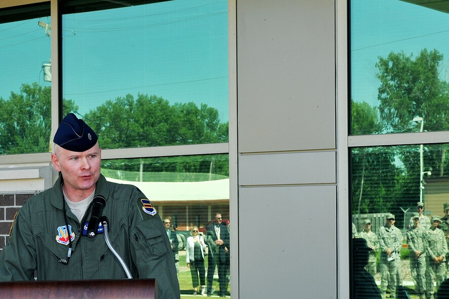 OFFUTT AIR FORCE BASE, Neb. - Lt. Col. Shane Smith, 97th Intelligence Squadron commander, addresses the audience at the ribbon cutting ceremony for the squadron's new building June 29. The new 54,000 square foot building is primarily a special compartmented information facility to support the squadron?s approximately 850 personnel and is the base's second Silver Level Leadership in Energy and Environmental Design Green building. U.S. Air Force photo by Charles Haymond