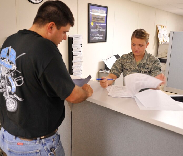 BARKSDALE AIR FORCE BASE, La. -- Airman 1st Class Amber Reim, 2d Comptroller Squadron customer service technician, helps a customer with a travel voucher request. The Barksdale finance office is available to assist customers with questions regarding pay, travel vouchers, permanent-change-of-station moves and any other questions a customer may have. (U.S. Air Force photo by Staff Sgt. John Gordinier) (RELEASED)