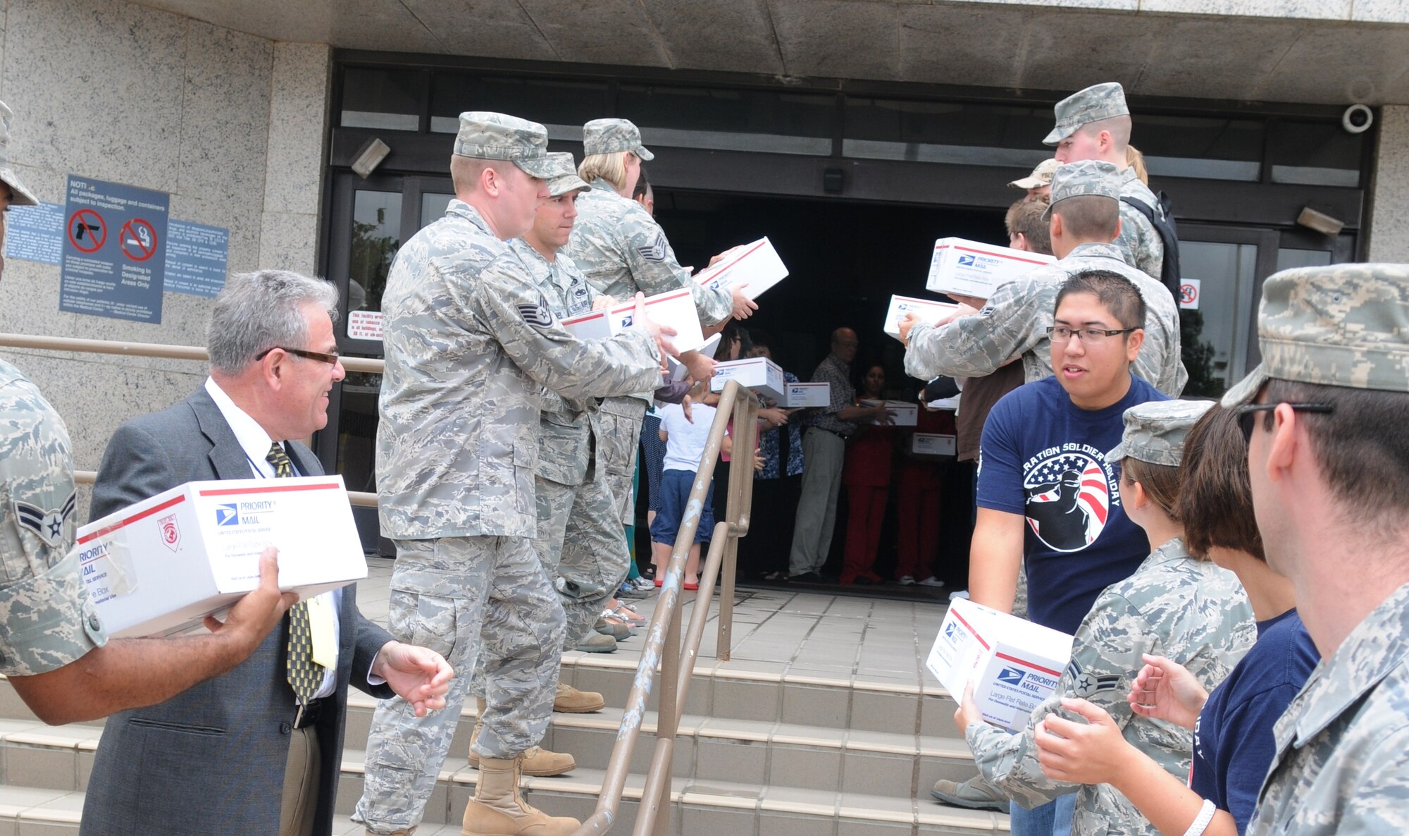 BIG SPRING, Texas -- Volunteers from Goodfellow Air Force Base and the West Texas VA Medical Center in Big Spring, Texas, load care packages onto a bus headed for Dyess Air Force Base, Texas, June 29. (U.S. Air Force photo/Airman 1st Class Clayton Lenhardt)
