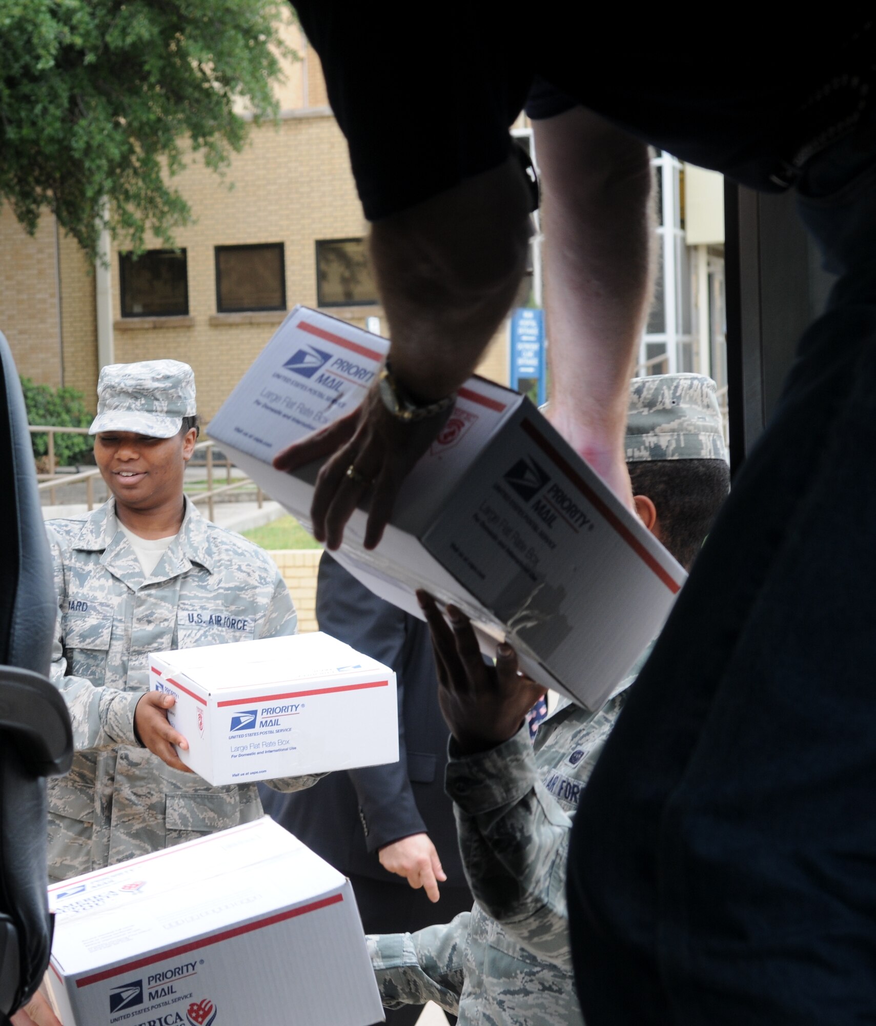 BIG SPRING, Texas -- Staff Sgt. Tiffany Howard, 17th Communications Squadron, helps load care packages onto a bus headed for Dyess Air Force Base, Texas, June 29. Sergeant Howard was one of several volunteers from Goodfellow to (U.S. Air Force photo/Airman 1st Class Clayton Lenhardt)