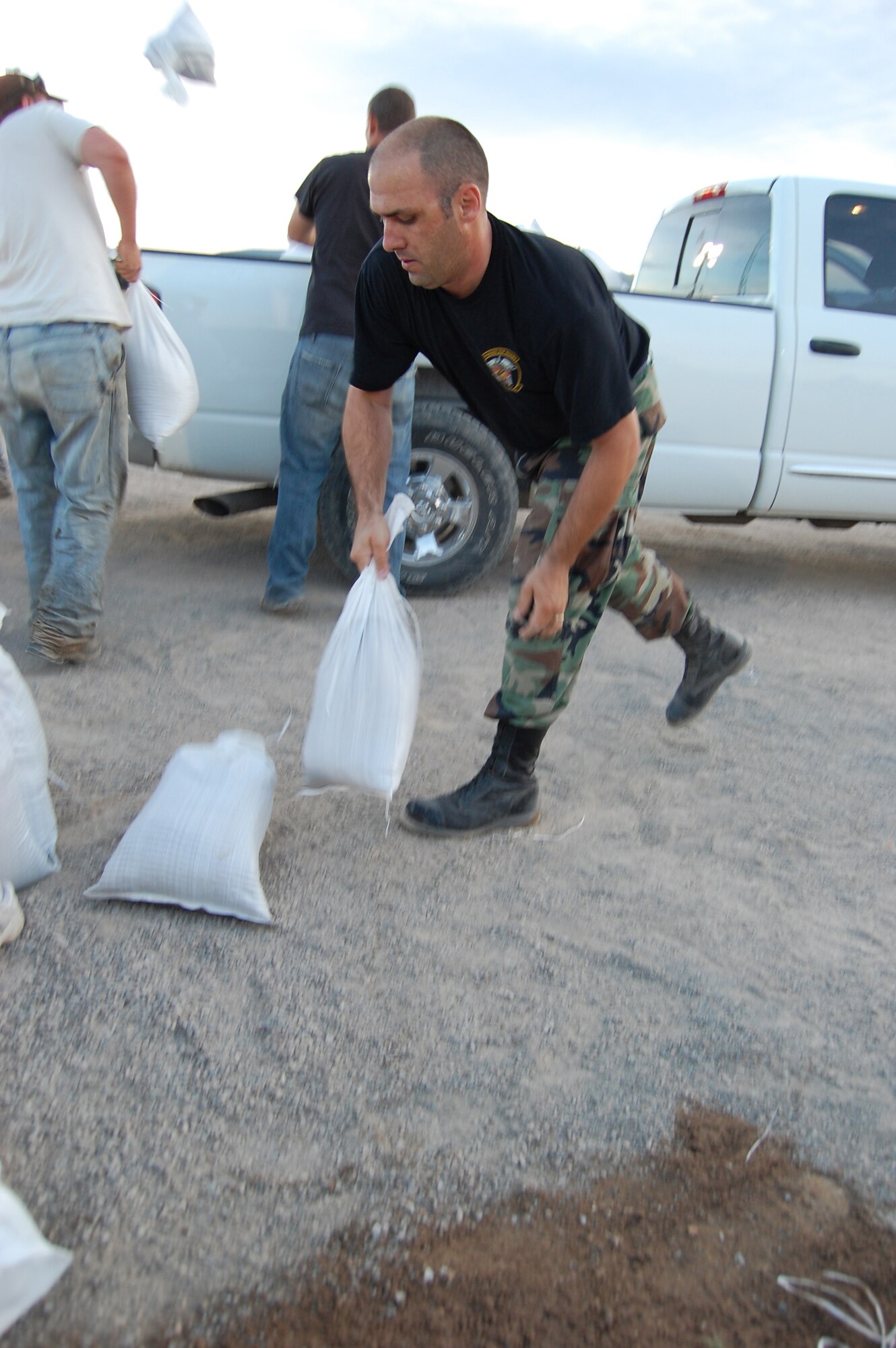 Staff Sgt. Rodney Massengill, of Cheyenne, Wyo., a member of the Wyoming Air National Guard's 153rd Medical Group, tosses sandbags in an effort to mitigate rising flood waters of the Popo Agie River, in Fremont County, Wyoming.  Massengill is assigned to the Wyoming National Guard Task Force 2-300th, for this state active duty mission. (Released)