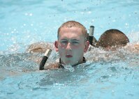 Airman Luke Edwards, a student in the pararescue indoctrination course, recovers after completing a buddy breathing exercise at the Chaparral pool June 22. The 10-week course trains students through intense physical and mental training. The dropout rate during the Pararescue Indoctrination Course is typically 60 to 70 percent.  (U.S. Air Force photo/Robbin Cresswell)