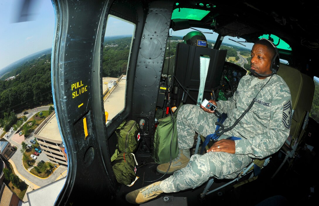 Chief Master Sgt. Anthony Brinkley, 316th Wing command chief, gets a birds-eye view of the National Capital Region as he surveys the landscape moments prior to landing on a landing pad atop George Washington Hospital, Washington D.C., during an immersion with the 1st Helicopter Squadron June 25. Chief Brinkley received an overview of the 1 HS specialized mission.