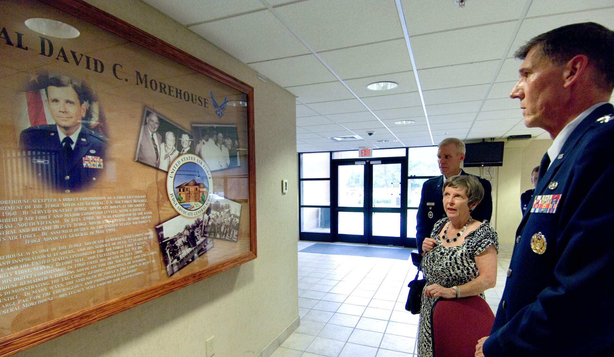 From left, Col. Timothy O’Brien, Sally Morehouse and Lt. Gen. Richard Harding admire the storyboard of retired Maj. Gen. David Morehouse on display in Officer Training School’s Morehouse Hall. The dormitory, Building 1491, was renamed June 24 in honor of General Morehouse, who was Judge Advocate General, Headquarters U.S. Air Force, from 1991 to 1993. (U.S. Air Force Photo/Melanie Rodgers Cox)