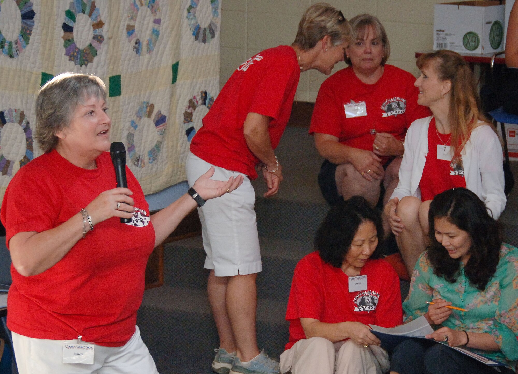 Peggy Funk talks with the wives of international officers at the International Family Orientation Program, or IFOP. This two-week program helps the spouses of international officers adapt to residing in the U.S. Mrs. Funk has been an IFOP volunteer for 25 years. (U.S. Air Force photo/Donna Burnett)