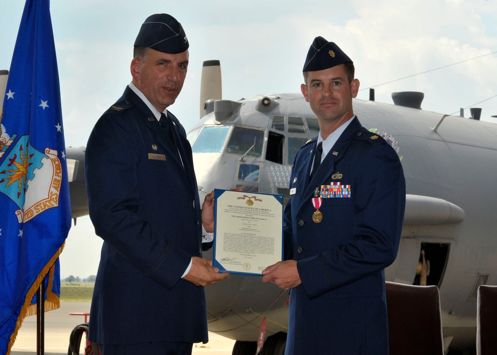U.S. Air Force Col. Mark LaRose, 27th Maintenance Group commander, presents U.S. Air Force Maj. Ryan White with the Meritorious Service Medal at Cannon Air Force Base, N.M., July 1, 2010. The Meritorious Service Medal is presented to members of the United States Armed Forces who distinguish themselves by outstanding non-combat meritorious achievement or service to the United States.  (U.S. Air Force photo by Staff Sgt. Heather R. Redman)
