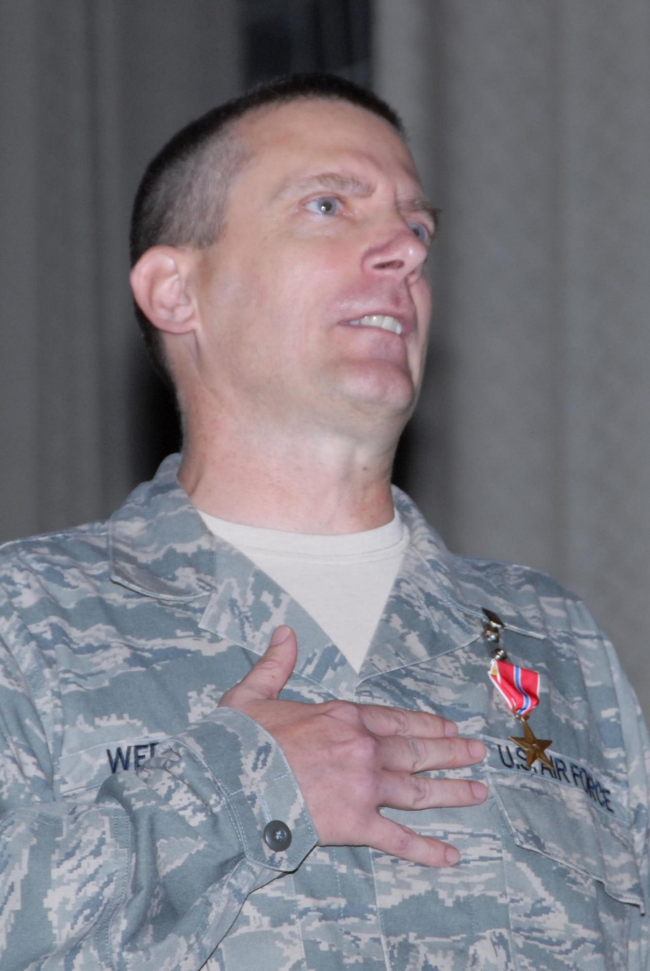 Chief Master Sgt. Jeffrey C. Wepner, 42nd Air Base Wing command chief, receives a Bronze Star from Col. Kris D. Beasley, 42nd ABW commander Wednesday in the base theater. Chief Wepner earned his Bronze Star while stationed with the 732nd Air Expeditionary Group, 332nd Air Expeditionary Wing, Joint-Forces Base Balad, Iraq.(U.S. Air Force photo/Bennett Rock)