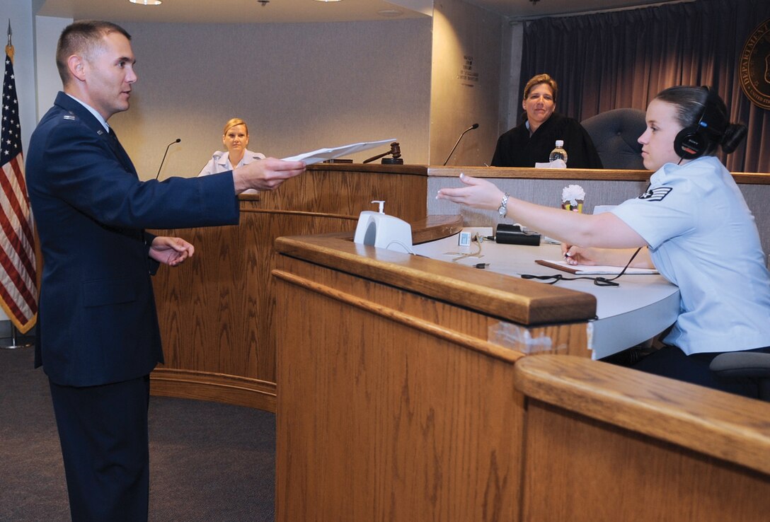 Captain Miguel Acosta, 316th Wing Judge Advocate chief of adverse actions, and Staff Sgt. April Bosquez, 316th Wing JA paralegal, practice trial procedures in the court room June 28. The JA office provides legal services that support the operation, people, infrastructure, and security of the installation. (U.S. Air Force photo/ Senior Airman Melissa Brownstein)