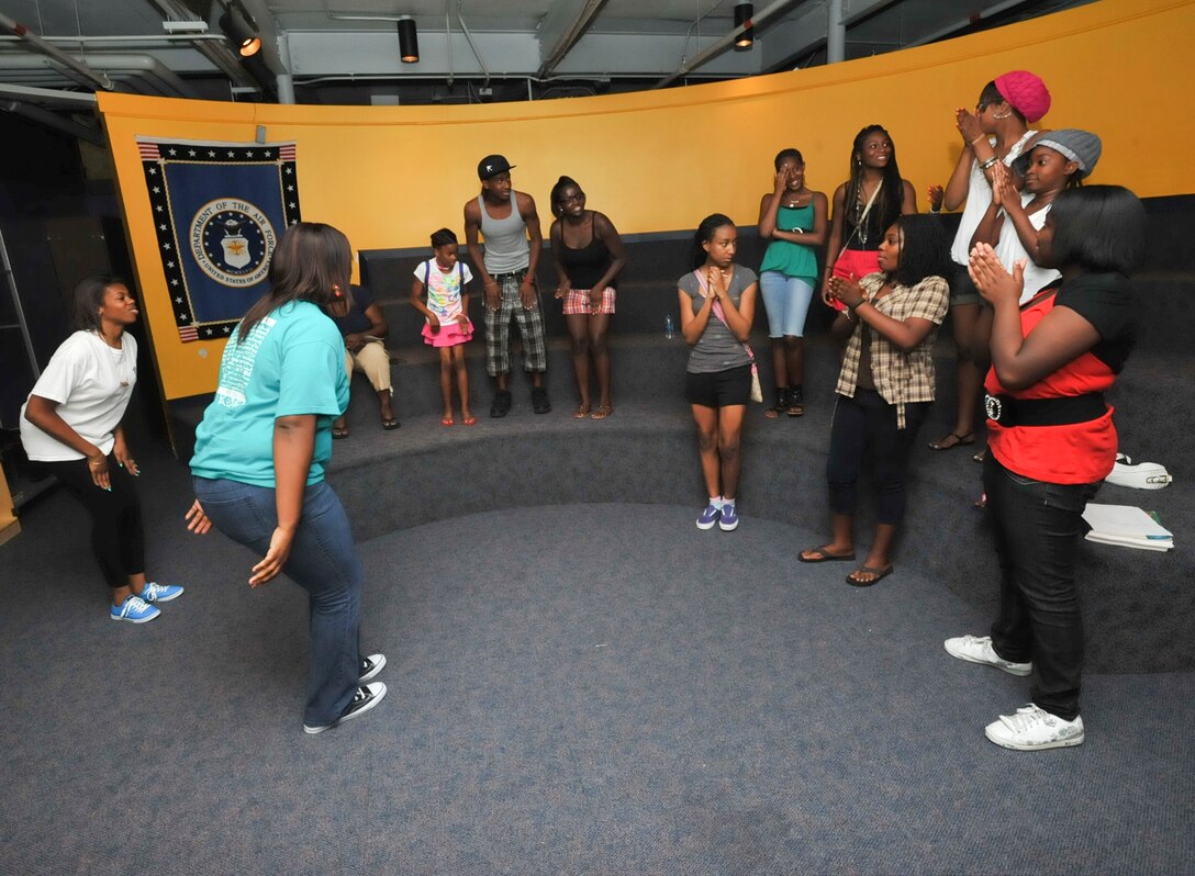 Andrews Youth Center Child and Youth specialist, Camerie Porter, left, and Jacinta Porter guide several Andrews youth through a team breaker exercise during a SMART Moves Program in the Youth Center movie room June 25. The new program provides youth and teens with the knowledge, skills and self-esteem to help them avoid risky behaviors and situations, including involvement with alcohol, tobacco and other drugs. (U.S. Air Force photo/ Bobby Jones)