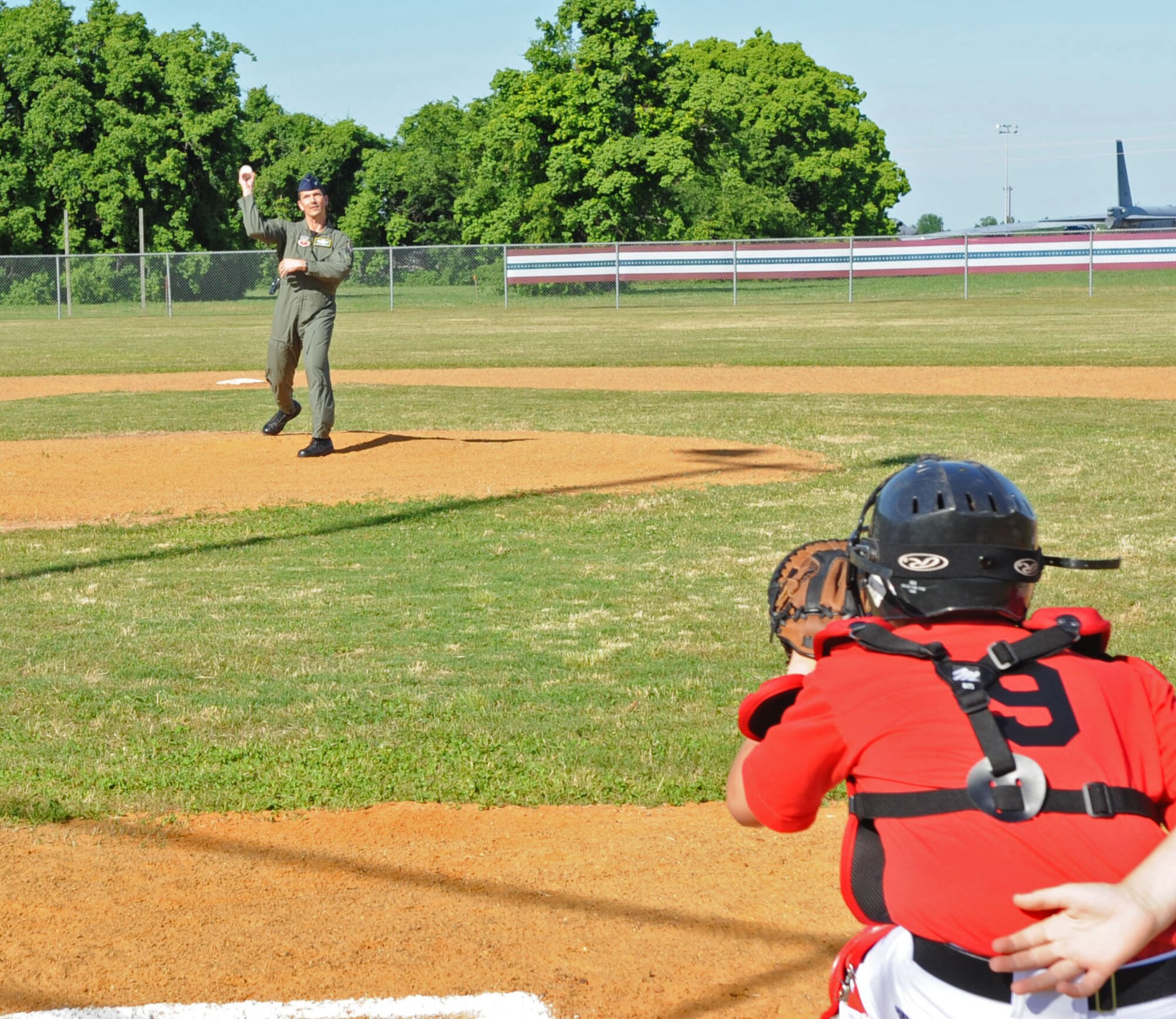 BARKSDALE AIR FORCE BASE, La. -- Col. Gerald Hounchell, 2d Bomb Wing vice commander, throws the first pitch of the Little League Baseball game held May 19, 2009 to Austin Edmonds, 11, son of Master Sgt. Keith Edmonds, 2d Maintenance Squadron. (United States Air Force photo by Senior Airman Alexandra Boutte)