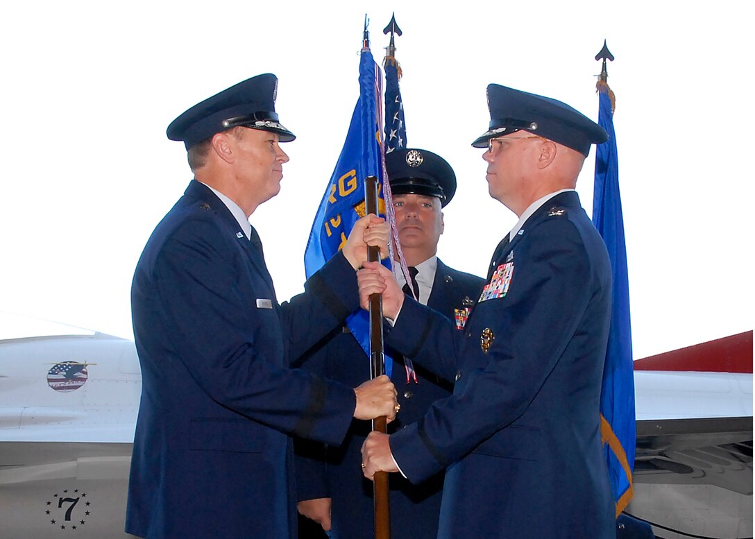 Brig. Gen. Darryl Burke (left),82nd Training Wing commander, passes the 782nd Training Group guidon to Col. Kenneth Backes (right), incoming 782nd TRG commander, at a change of command ceremony at Hangar 1010 on Sheppard Air Force Base, Texas, June 30, 2010. Colonel Backes was an instructor at the base in 1984. (U.S. Air Force photo/ Mike Litteken)