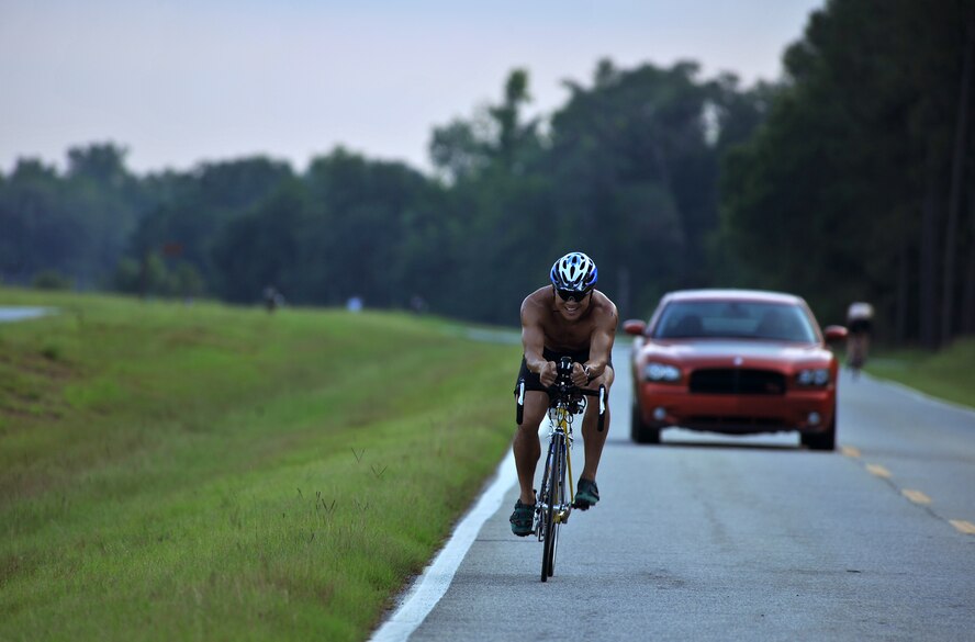 MOODY AIR FORCE BASE, Ga. -- Master Sgt. Samuel Louie, 820th Combat Operation Squadron NCO in-charge of air operations, rides his bike for the second portion of a triathlon event here June 25. The bike portion consisted of 13 miles where participants ride to the base air traffic control tower twice and then begin their run. (U.S. Air Force photo by Airman 1st Class Joshua Green/RELEASED)