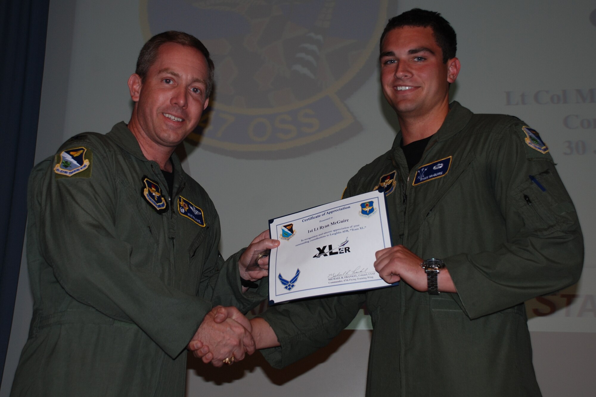 LAUGHLIN AIR FORCE BASE, Texas – First Lt. Ryan McGuire, 47th Operations Support Squadron, is presented the XLer of the Week award by Col. Michael Frankel, 47th Flying Training Wing commander, June 30. The XLer is a weekly award chosen by 47th FTW leadership and given to individuals who consistently make outstanding contributions to Laughlin and their unit. (U.S. Air Force photo by Airman 1st Class Blake Mize)