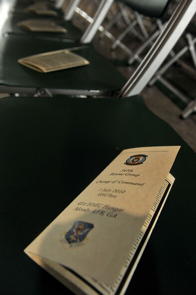 MOODY AIR FORCE BASE, Ga. -- A program for the 347th Rescue Group change of command ceremony lays on the seats of distinguished visitors here July 1. The ceremony is for outgoing commander Col. Darryle Grimes and incoming commander Col. Chad Franks. (U.S. Air Force photo by Airman 1st Class Joshua Green/RELEASED)