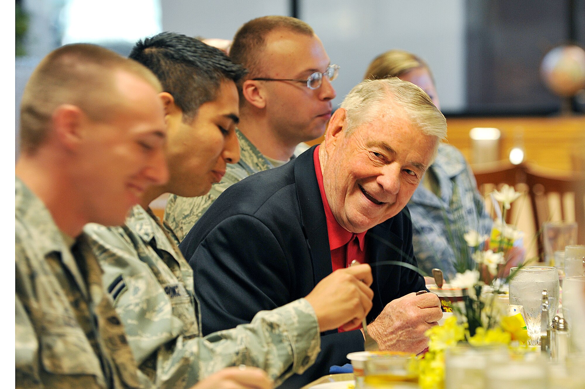 OFFUTT AIR FORCE BASE, Neb. - Retired Chief Master Sgt. Robert Gaylor, fifth chief master sergeant of the air force, speaks to Airman 1st Class Brandon Lester, general law paralegal with 55th WG/JA, during a morning breakfast inside the Ronald L. King dining facility June 29. Chief Gaylor has been spreading a message of maintaining positive attitudes and striving for technical aptitude at more than 30 air force bases every year during his retirement. U.S. Air Force photo by Charles Haymond
