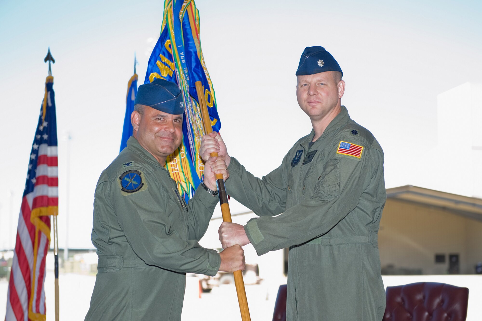 Lt. Col. Michael Kardoes accepts command of the 40th Helicopter Squadron from Col. Mohammed Khan, 341st Operations Group commande, June 28 at the 3 Bay Hangar. (U.S. Air Force photo / Beau Wade)
