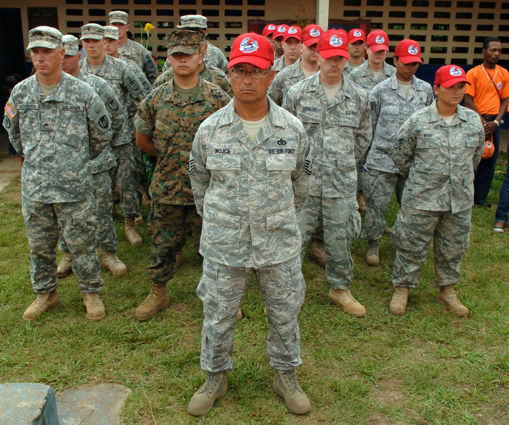 A formation of Soldiers, Sailors, Airmen and Marines stand at parade rest prior to the New Horizons Panama 2010 opening ceremony June 29, 2010, at Santa Librada Elementary School, in Meteti, Panama. (U.S. Air Force photo/Tech. Sgt Eric Petosky)