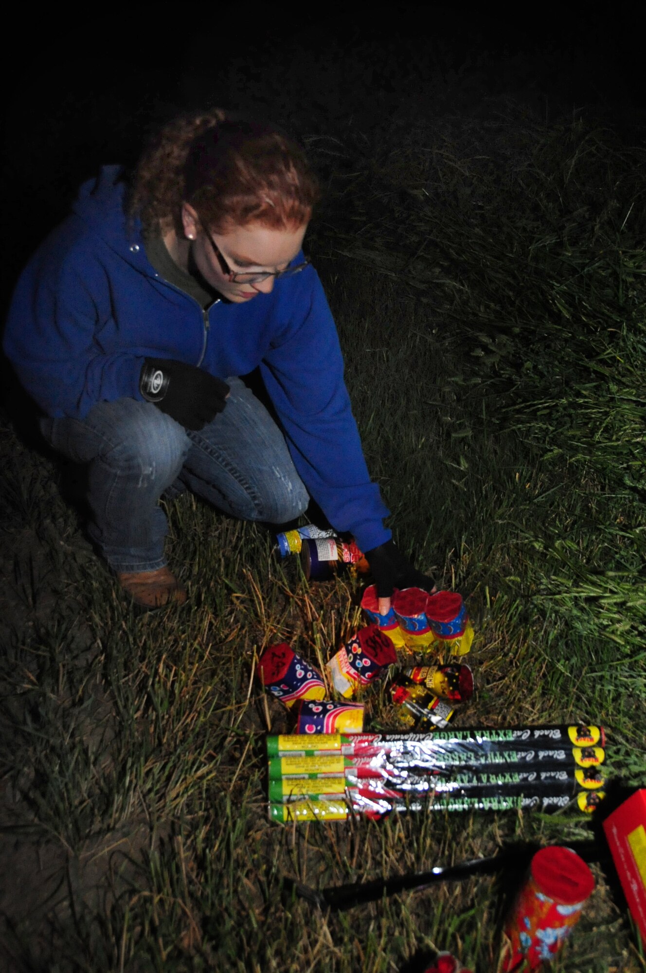 ELLSWORTH AIR FORCE BASE, S.D. -- 1st Lt. Amy Neeves, 28th Bomb Wing deputy chief of public affairs, selects fireworks to, Fairburn South Dakota, June 29.  It is important to read all directions and safety details on fireworks before lighting them. (U.S. Air Force photo/Airman 1st Class Anthony Sanchelli)