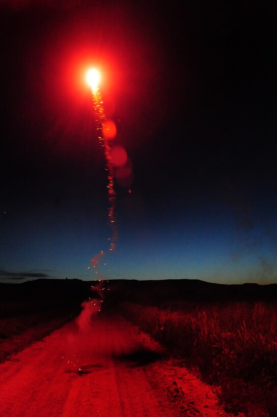 ELLSWORTH AIR FORCE BASE, S.D. -- A red glowing fire ball erupts from a firework, Fairburn South Dakota, June 29.  It is important to wear proper protective safety equipment such as safety glasses and gloves when lighting fireworks. (U.S. Air Force photo/Airman 1st Class Anthony Sanchelli)