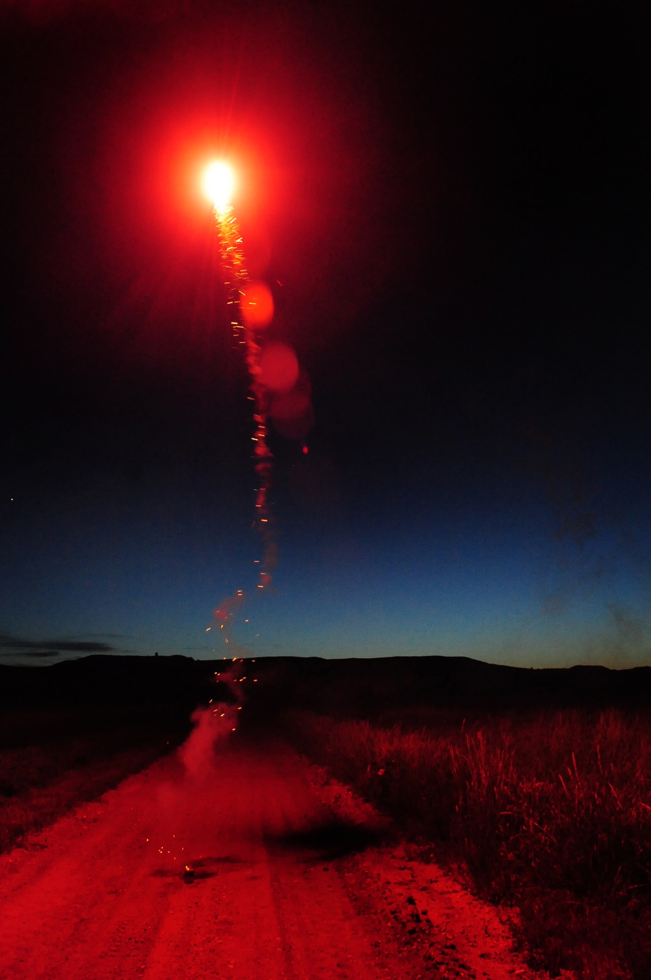 ELLSWORTH AIR FORCE BASE, S.D. -- A red glowing fire ball erupts from a firework, Fairburn South Dakota, June 29.  It is important to wear proper protective safety equipment such as safety glasses and gloves when lighting fireworks. (U.S. Air Force photo/Airman 1st Class Anthony Sanchelli)