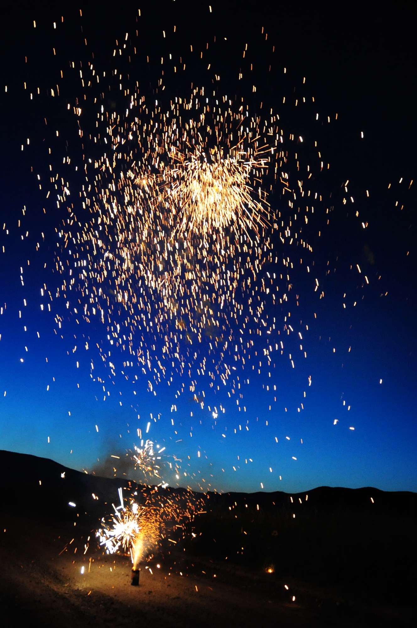 ELLSWORTH AIR FORCE BASE, S.D. -- A shower of sparks and exploding balls of fire erupt from a firework, Fairburn South Dakota, June 29.  Fireworks should always be handled safely due to explosives in the fireworks. (U.S. Air Force photo/Airman 1st Class Anthony Sanchelli)