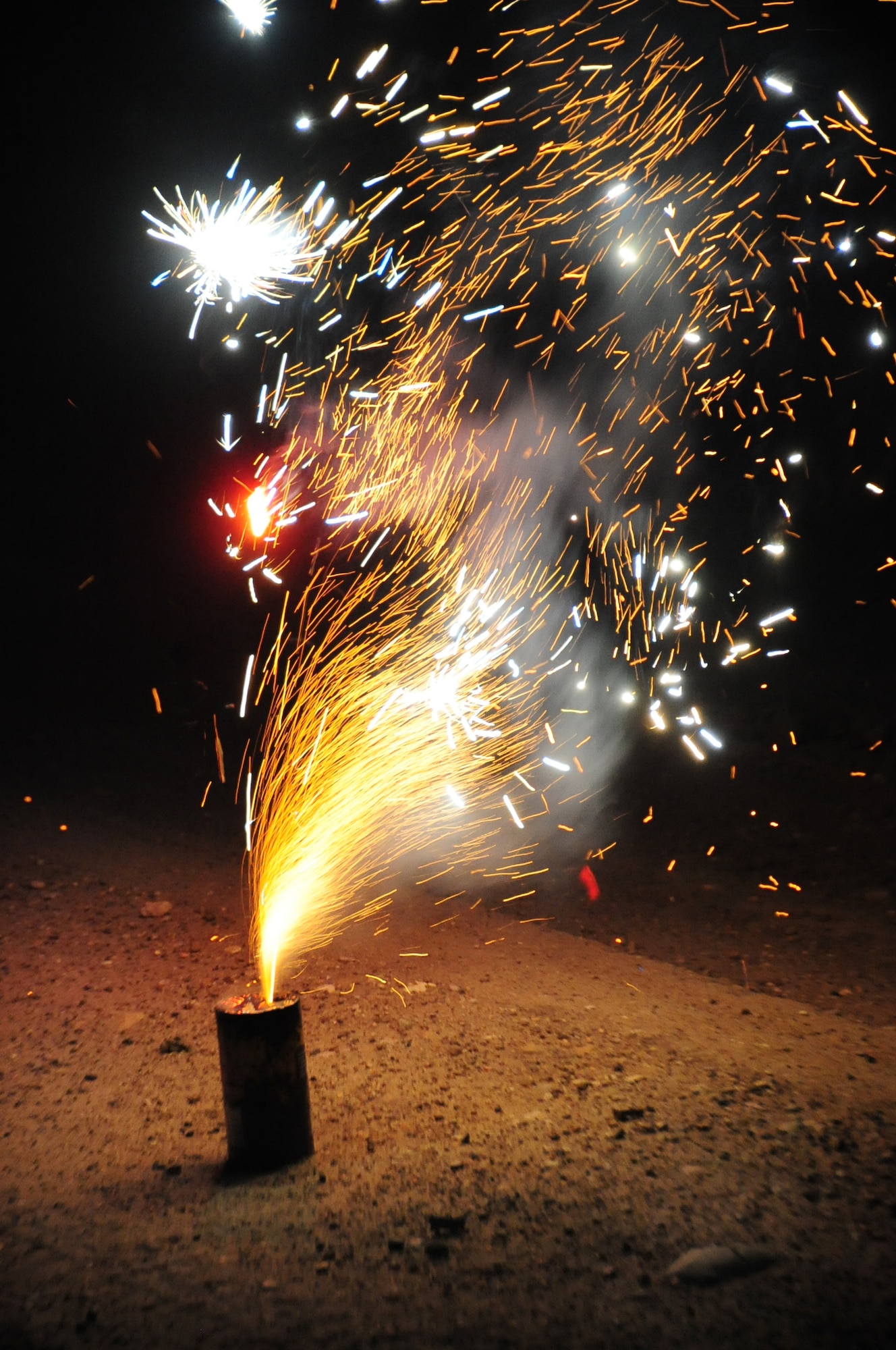 ELLSWORTH AIR FORCE BASE, S.D. -- A shower of sparks erupts from a fountain firework, Fairburn South Dakota, June 29.  Fireworks contain explosive material and must be handled carefully under adult supervision. (U.S. Air Force photo/Airman 1st Class Anthony Sanchelli)