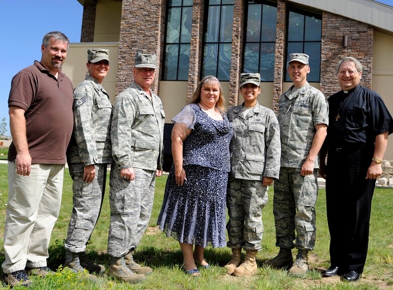 BUCKLEY AIR FORCE BASE, Colo. -- Buckley Chapel staff pose for a group pohoto June 22. Counseling sessions with chaplains can be scheduled by calling 720-847-GOD1, and can cover a wide variety of issues including relationship and family concerns, work issues, stress and anger management, suicidal thoughts, spiritual concerns and ethical issues. However, in an emergency, the on-call chaplain can be reached through the 460th Space Wing Command Post at any time. (U.S. Air Force photo by Staff Sgt. Dallas Edwards)